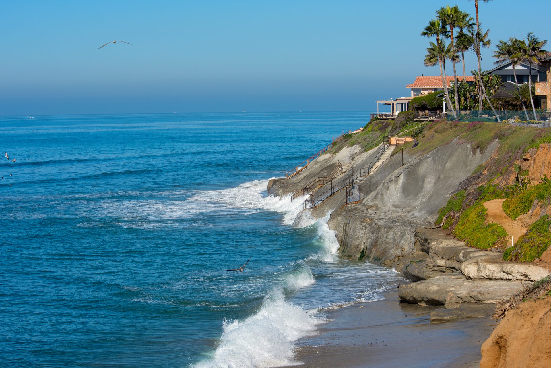 Carlsbad blufftop estate with dramatic ocean views and sandy beach below